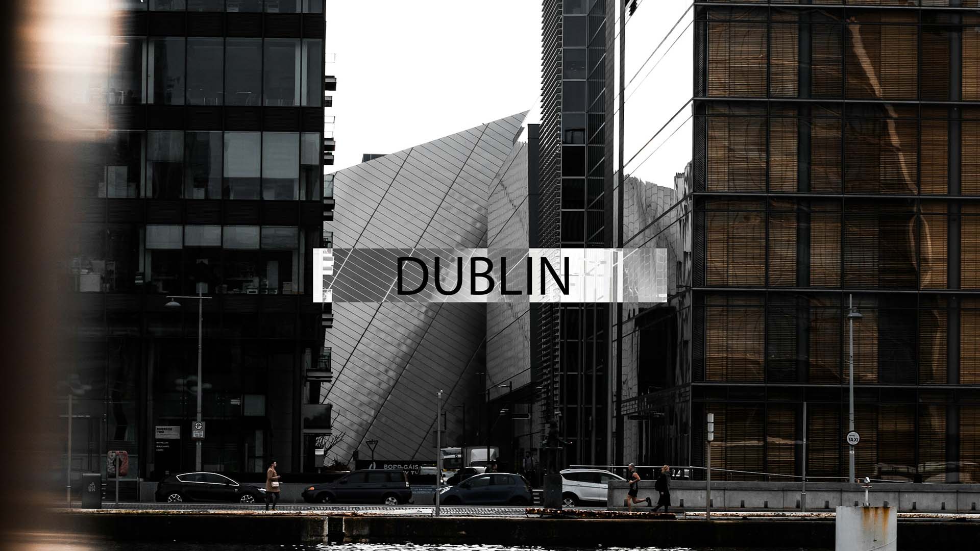 Dublin City, at the banks of the river Liffey looking towards the stylish and modern south docks buildings - Chauffeur Driver Tours of Ireland