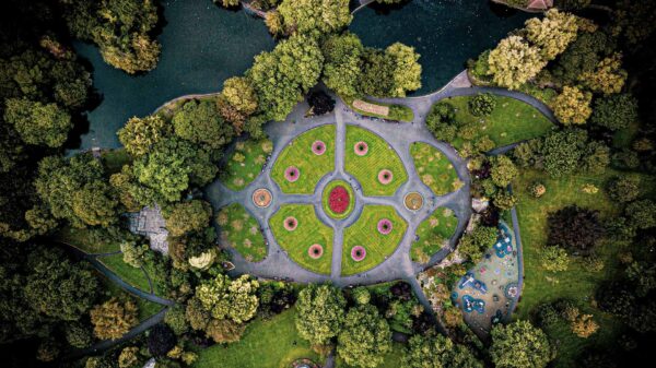 Dublin City - an aerial view of St. Stephen's Green showing the green areas of the centre of the park surrounded by trees and with pathways in between creating a geometric shape for people to enjoy.