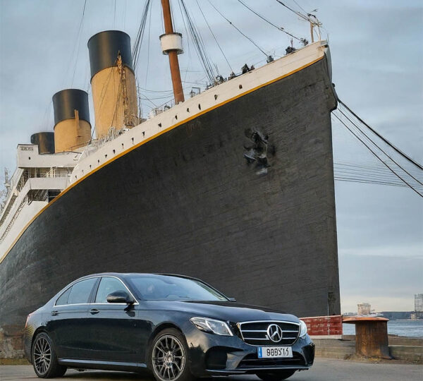 Titanic and Belfast private driver tour - an AI generated photograph showing the ship and a Mercedes E class car