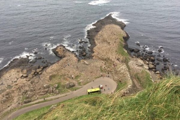 An arial shot taken from directly above The Giant's Causeway showing the where the sea meets a small headland near the site.