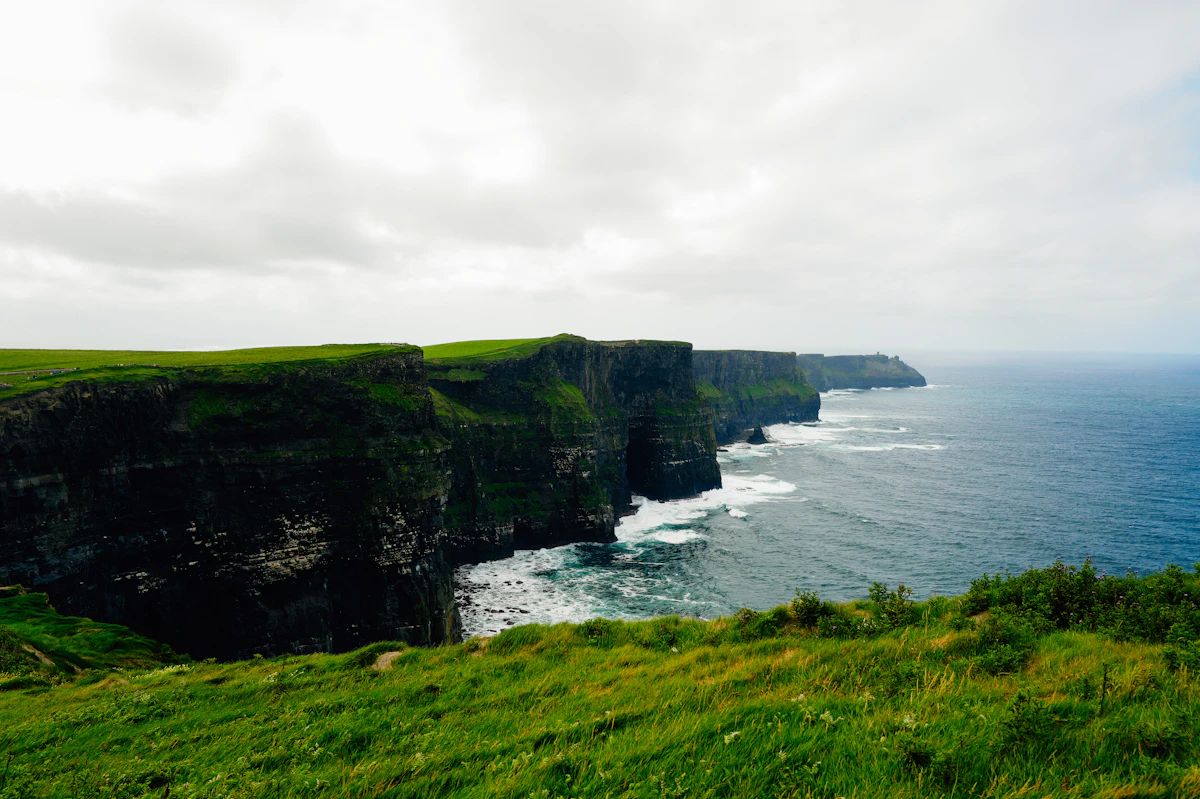 Atlantic waves crashing below Ireland coastal cliffs on a golf tour route